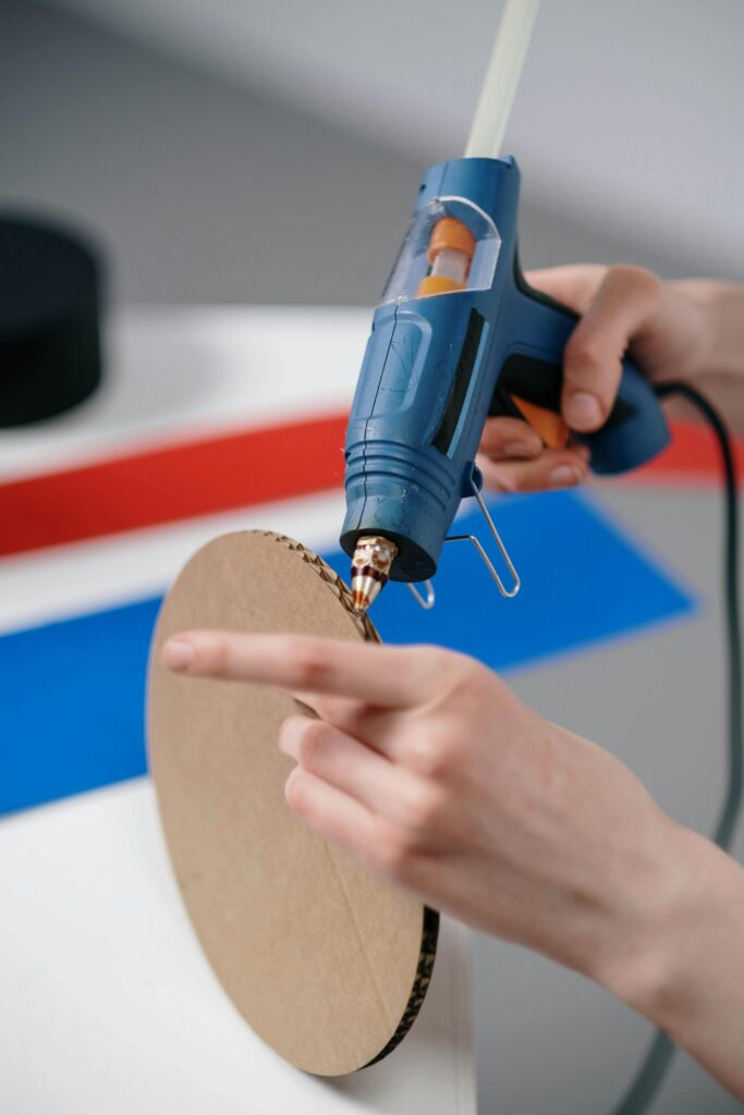Glue Gun A person is gluing a board with a glue gun.