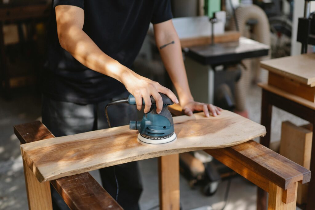 Random Orbital Sander A Random Orbital Sander is providing smooth finishing on wood.