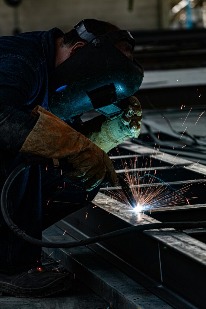 Welding Machine A man is operating a welding machine to join metal.