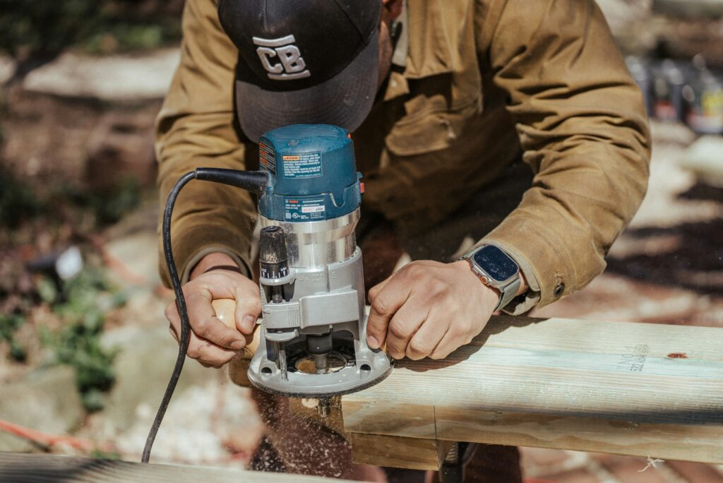 Wood Router A corded wood router is cutting through wood.